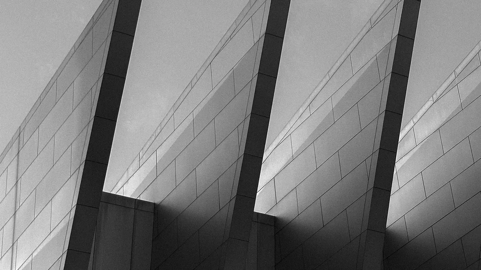 Commodities Securitization 1 Three angled facade fins repeating against the sky — commodities securitization